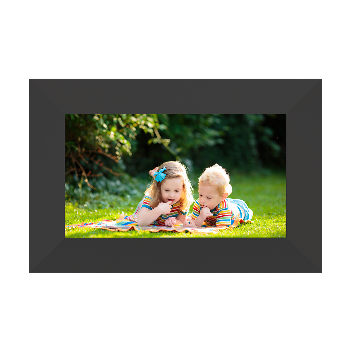 Digital photo frame displaying two children on a grassy field