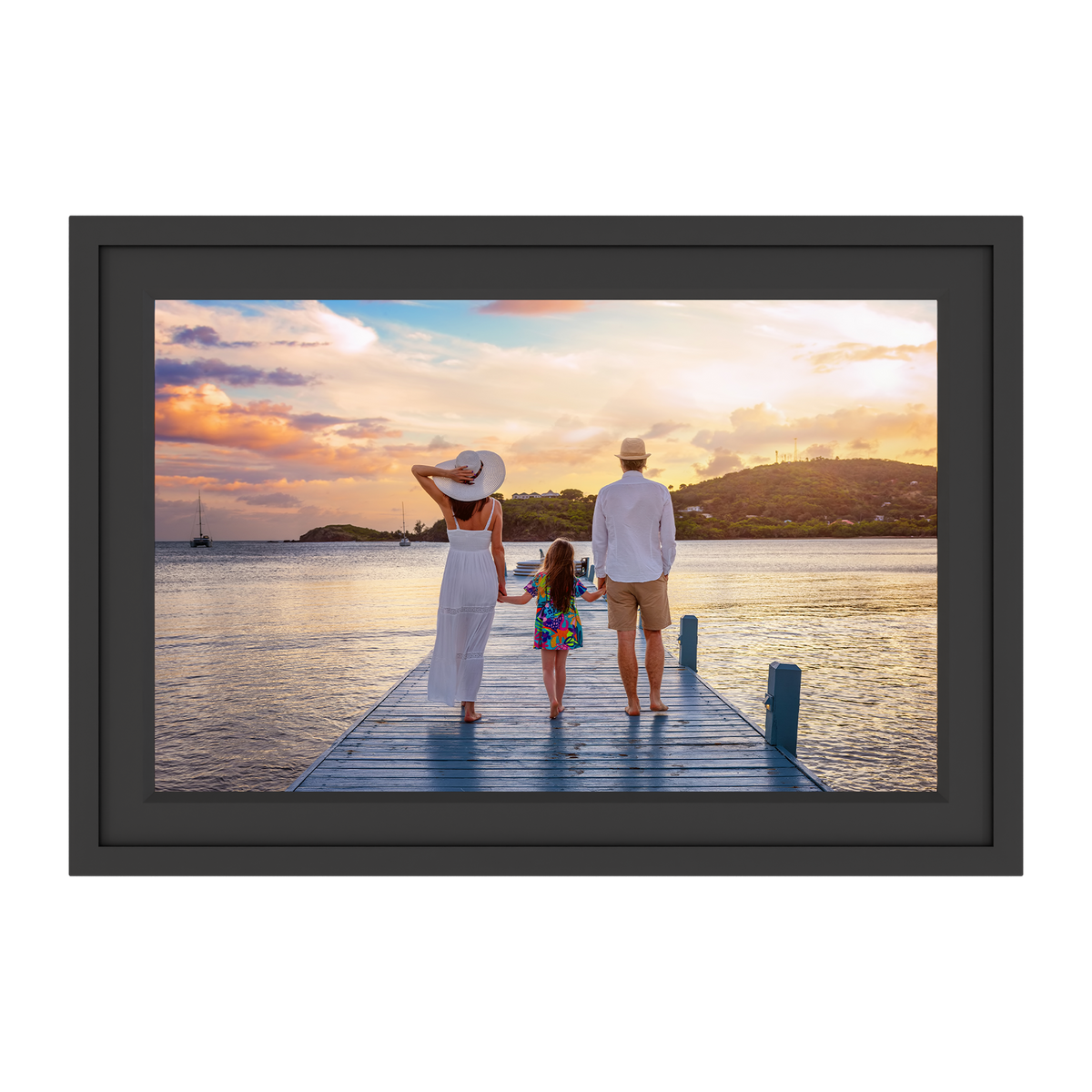 Framed photograph of a family on a dock at sunset.