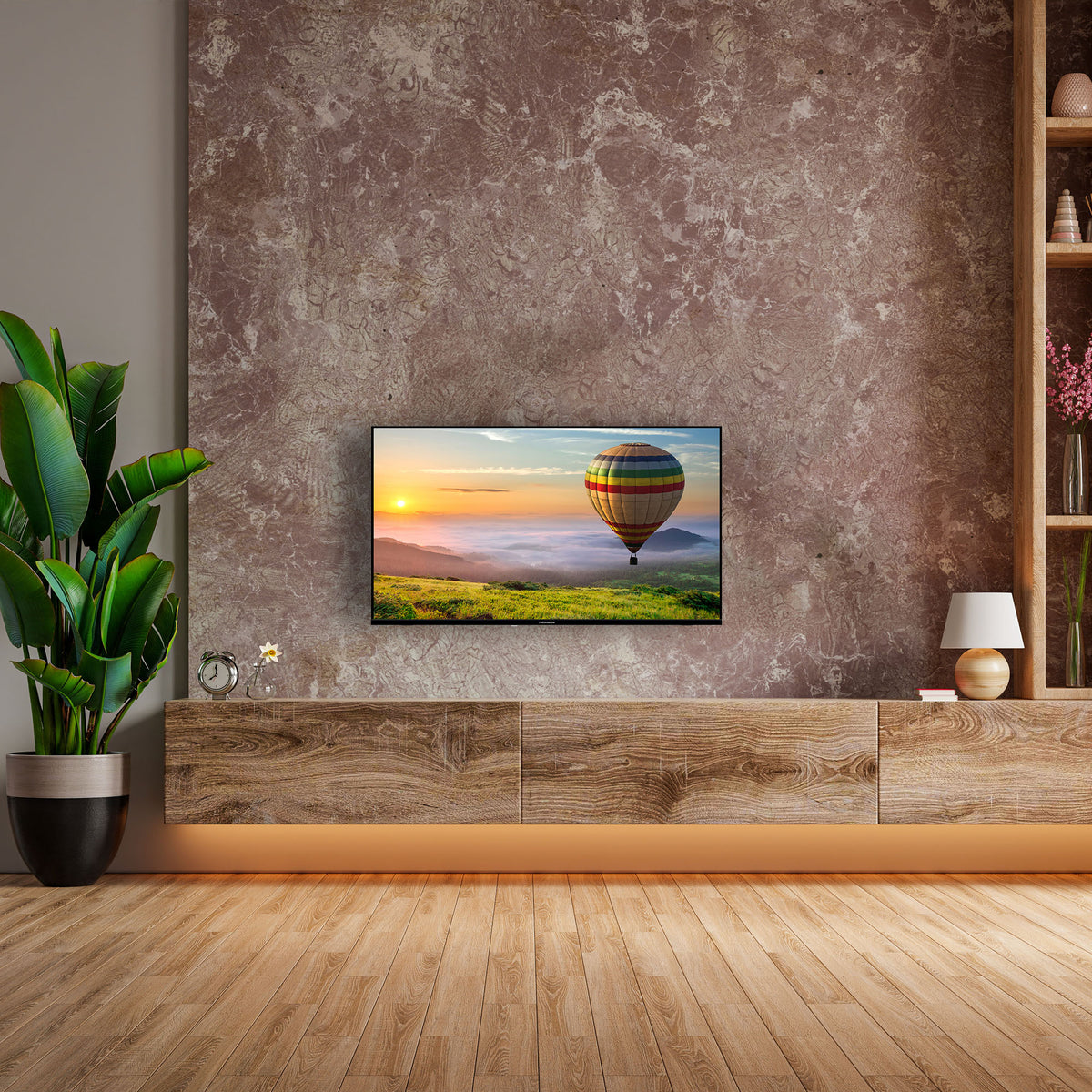 Modern living room with a TV displaying a hot air balloon scene, wooden cabinet, and decorative items.