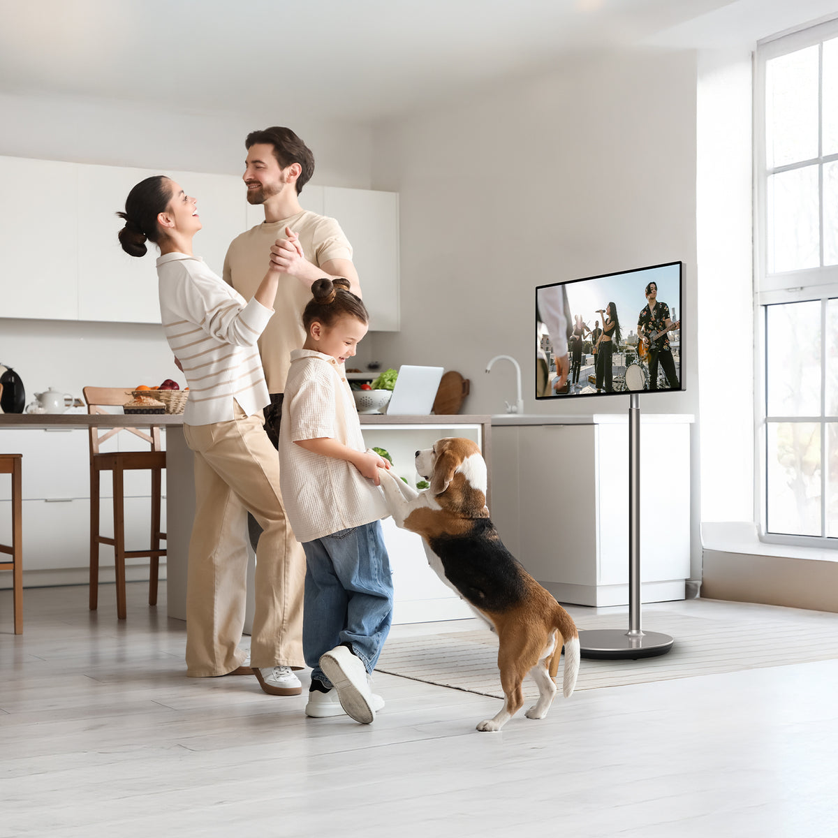 Family with a dog in a modern living room with a portable TV displaying a movie.