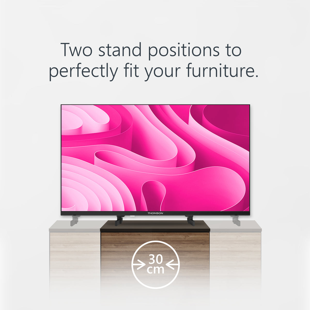 Smart TV on a stand with pink abstract screen fill design and text about stand positions.