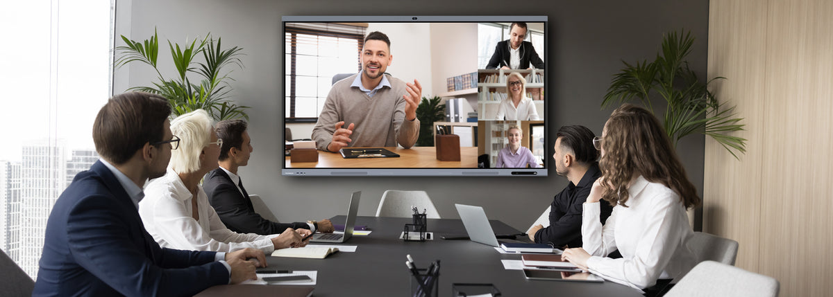 Group of people in a video conference call in a modern office setting.